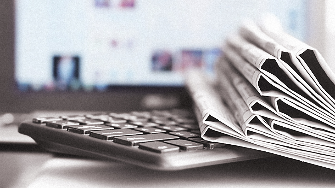 Newspapers and Laptop